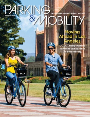 Two people riding bicycles on the cover of Parking & Mobility magazine showcasing mobility.