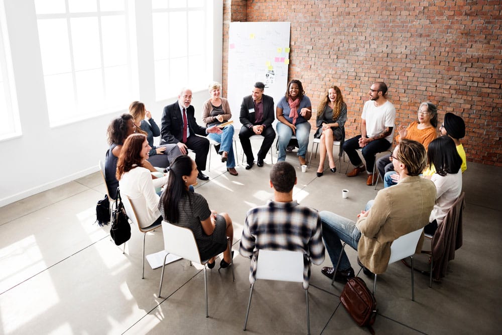 Group of business people having an informal meeting while sitting in a circle