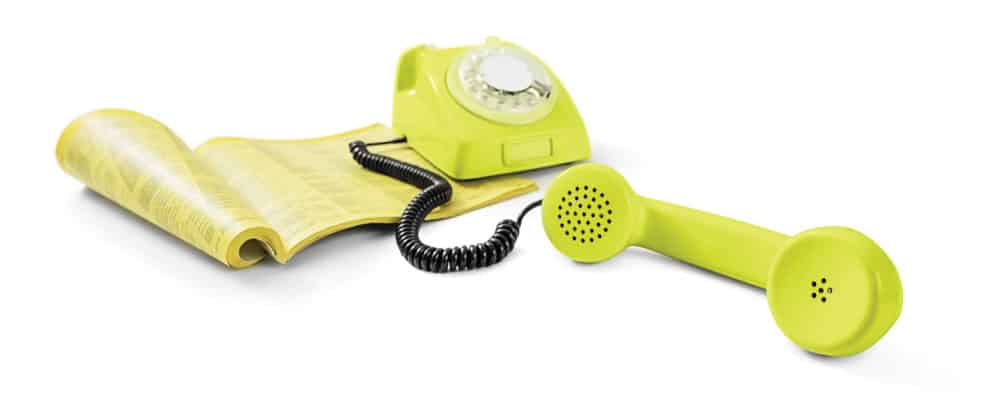 A yellow telephone on a white background in a Smart City.