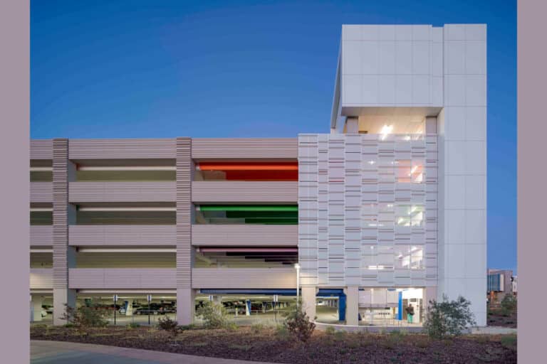 A parking garage at UC Davis Health Center with colorful lights on it, designed by Watry Design.